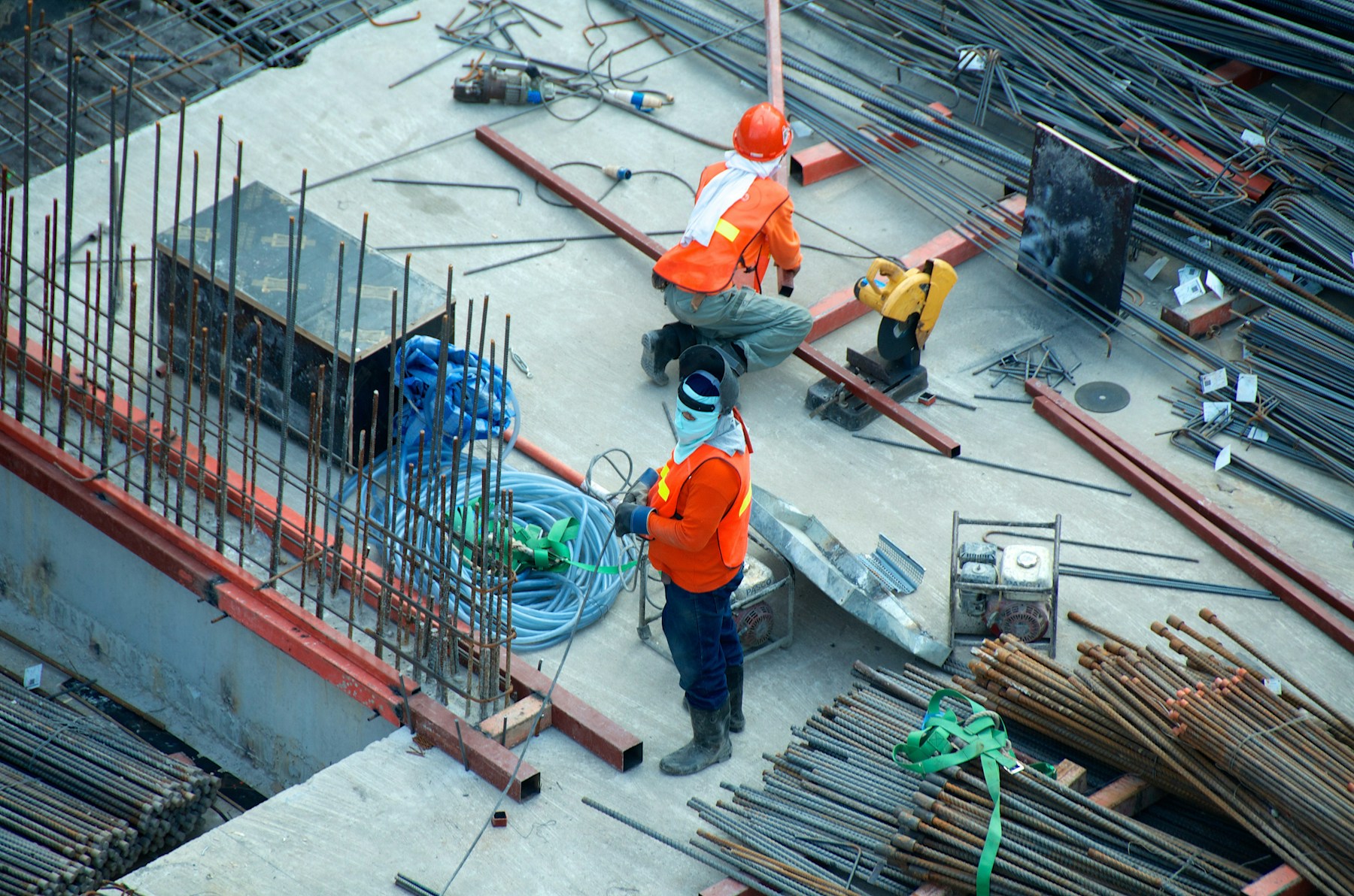 Two construction professionals working on an active building site