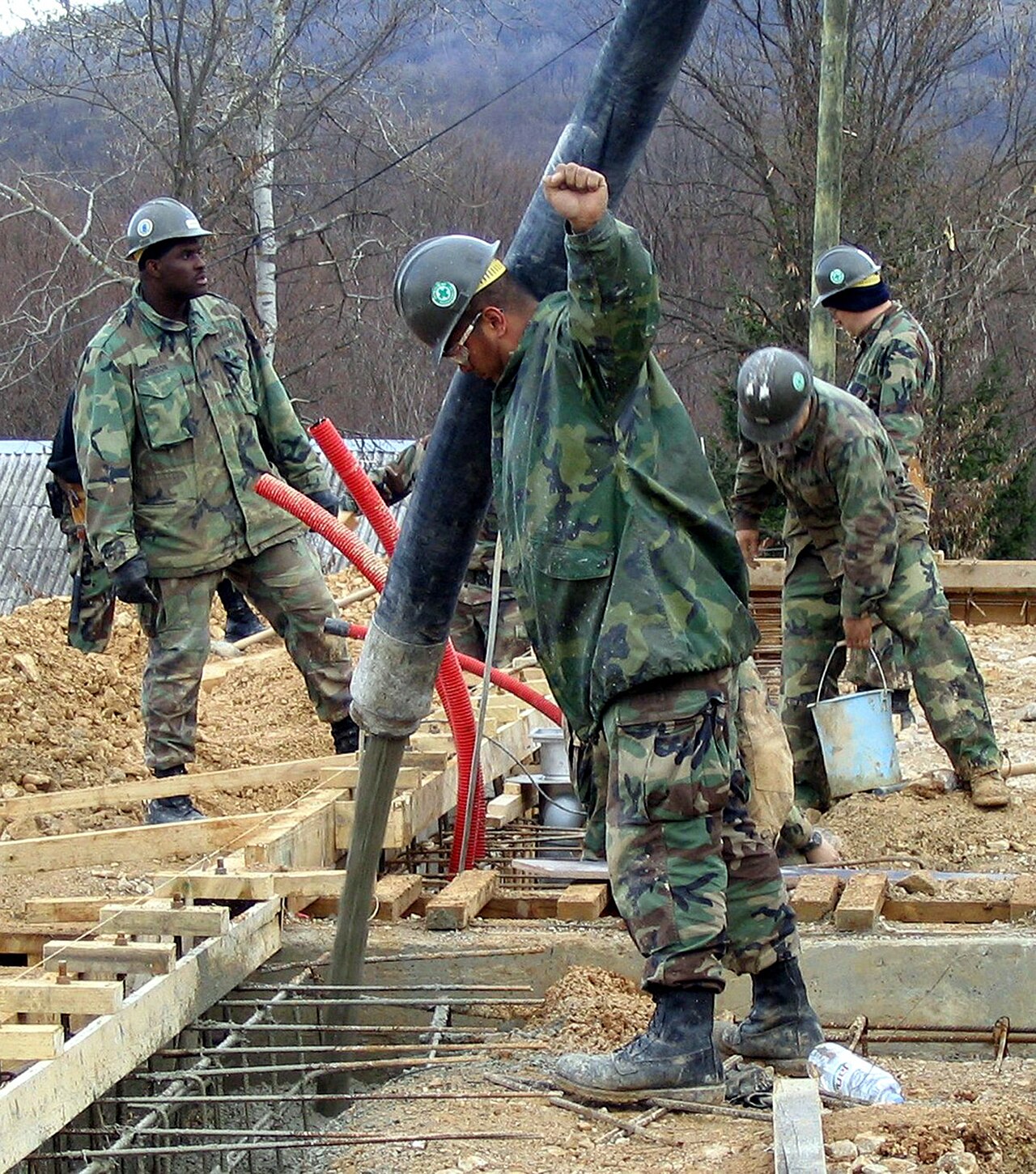 Example of a crew pouring concrete into forms
